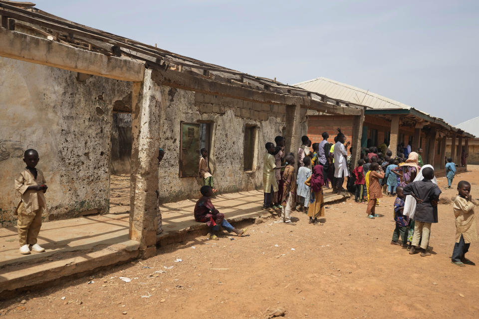 Children play at the LEA Primary and Secondary School Kuriga where students were kidnapped in Kuriga, Kaduna, Nigeria, Saturday, March 9, 2024. Security forces swept through large forests in Nigeria's northwest region on Friday in search of nearly 300 children who were abducted from their school a day earlier in the West African nation's latest mass kidnap which analysts and activists blamed on the failure of intelligence and slow security response. (AP Photo/Sunday Alamba)