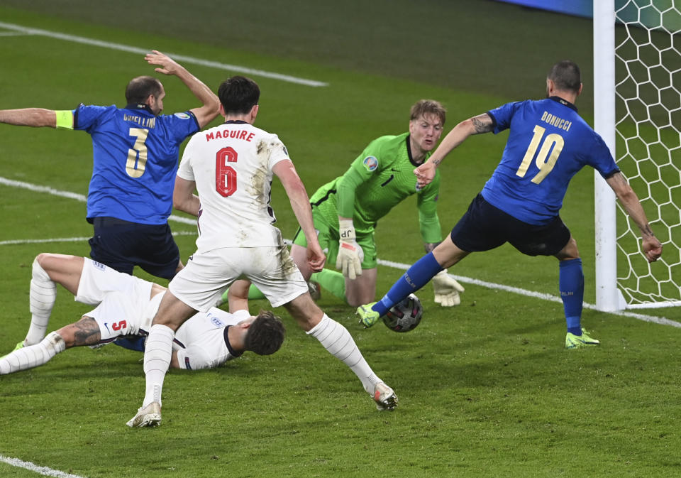 Italy's Leonardo Bonucci, right, scores his side's opening goal during the Euro 2020 final soccer match between Italy and England at Wembley stadium in London, Sunday, July 11, 2021. (Facundo Arrizabalaga/Pool via AP)