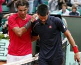 Spain's Rafael Nadal (left) consoles Serbia's Novak Djokovic after defeating him in the final of the French Open in Paris on June 11. Nadal clinched a record seventh French Open title on Monday, defeating world number one Djokovic 6-4, 6-3, 2-6, 7-5 and shattering the Serb's dream of Grand Slam history