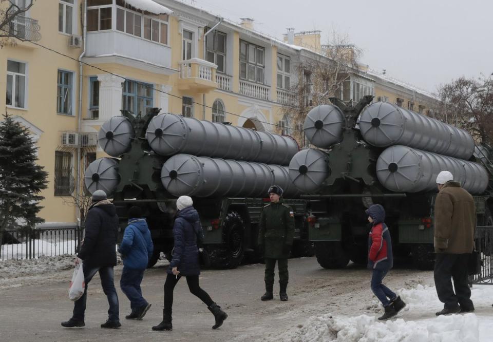 People walk past Russian S-400 missile air defence systems before a military parade in Volgograd in 2018 (Reuters)