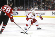 Carolina Hurricanes defenseman Ian Cole (28) plays the puck against New Jersey Devils defenseman Damon Severson (28) during the second period of an NHL hockey game, Saturday, Jan. 22, 2022, in Newark, N.J. (AP Photo/Noah K. Murray)