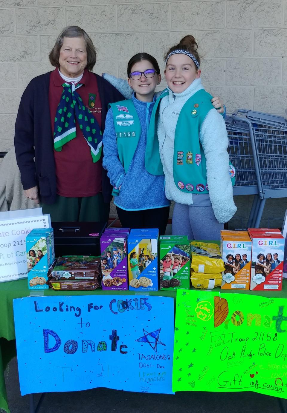 Oak Ridge Girl Scout leader Jerralyn Luckmann and Troop 21158 members Danielle Ellis and Vivian Sullivan sell Girl Scout cookies at their booth last year.