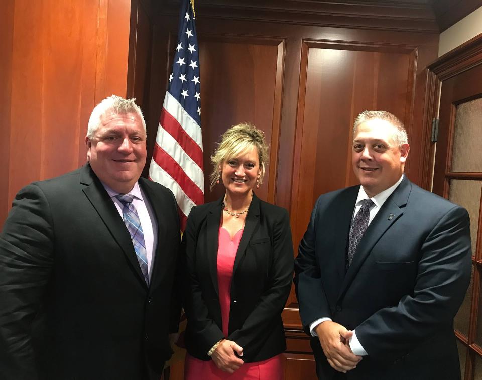 Erie County District Attorney Elizabeth Hirz, center, is working with Erie police Detective Sgt. Craig Stoker, left, and Pennsylvania State Police Master Trooper Todd Giliberto to review and attempt to solve a number of unsolved major crimes in Erie County, some of which are decades old.