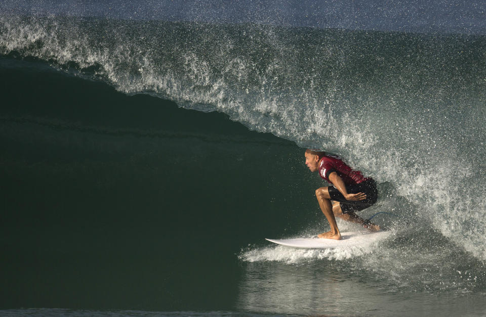 ILE - In this May 12, 2015, file photo, Kelly Slater competes in the Oi Rio Pro World Surf League event at Barra da Tijuca beach in Rio de Janeiro, Brazil. Professional surfers will be riding the waves again Sunday, Aug. 9, 2020, for the first time since the coronavirus pandemic shut down the sport in March. The Surf Ranch in Lemoore, Calif., some 100 miles from the Pacific Ocean, will provide a perfect bubble for the World Surf League’s Rumble at the Ranch featuring 16 surfers, including 11-time world champion Slater and Olympic qualifiers Kolohe Andino, Caroline Marks and four-time reigning world champ Carissa Moore. (AP Photo/Leo Correa, File)