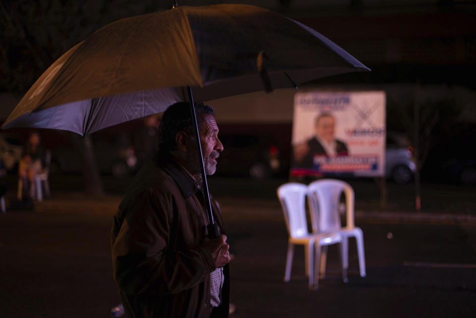 A supporter waits for Alejandro Giammattei, presidential candidate of the Vamos party, at his campaign headquarters during general elections in Guatemala City, Sunday, June 16, 2019.(AP Photo/Santiago Billy)