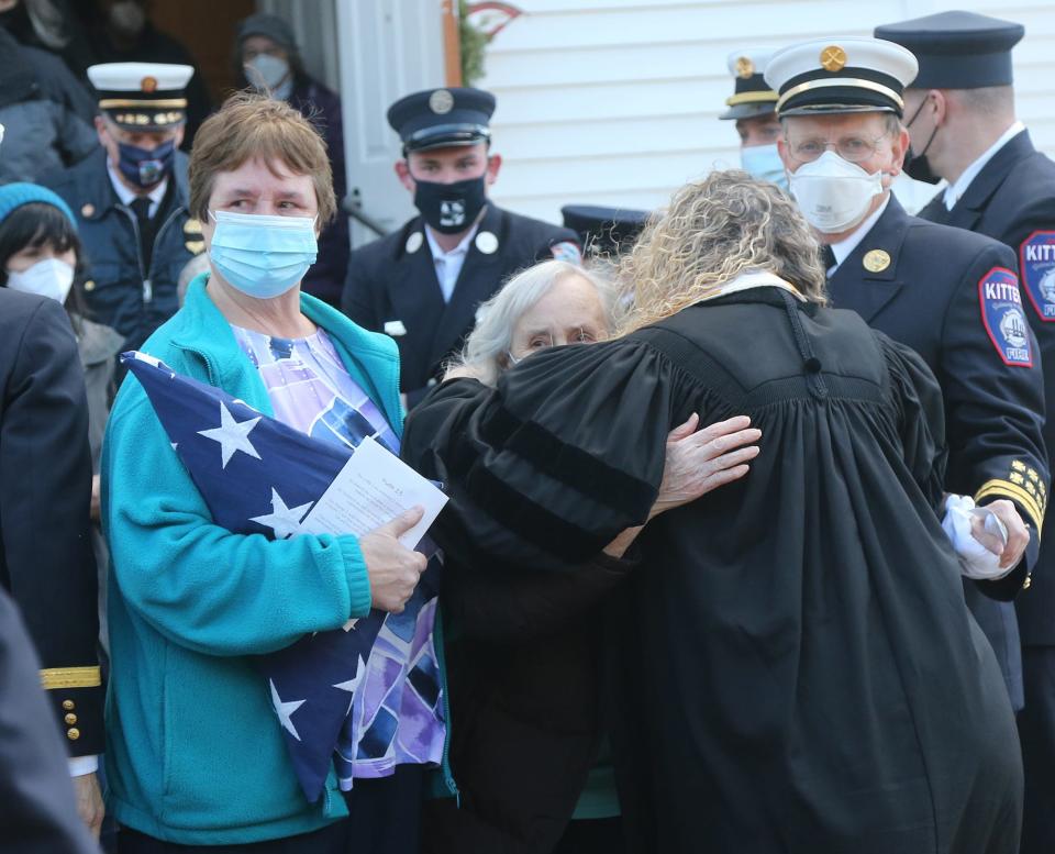 Joan (Fiske) Varney gets a hug from the Rev. Dr. Elizabeth Hoffman following the funeral of her husband, retired Kittery fire chief George D. Varney Jr. at First Congregational Church United Church of Christ in Eliot Tuesday, Jan. 18, 2022.