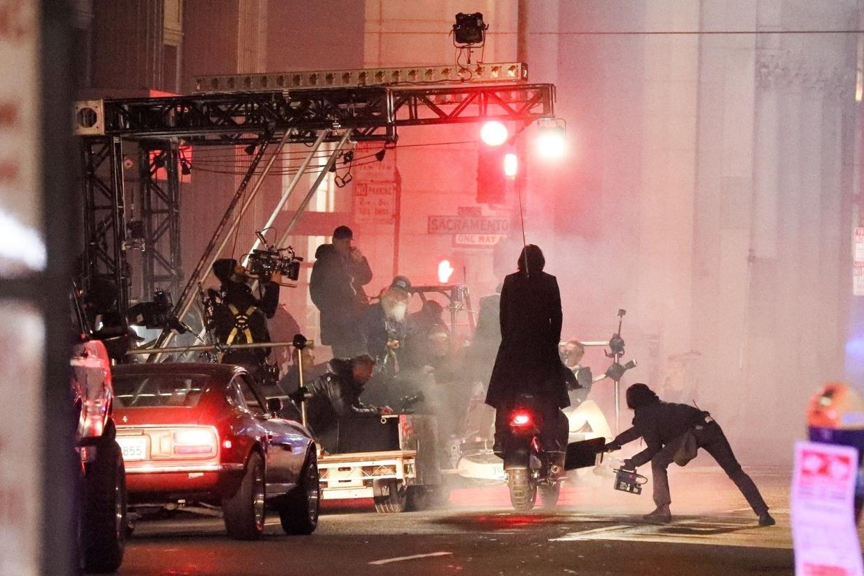 Keanu Reeves and Carrie-Anne Moss are spotted shooting scenes for "The Matrix 4" in San Francisco, Calif. on Feb. 16, 2020. The pair were shooting a late-night action sequence on a motorcycle, and Keanu who sported a more laid back look to his cyberpunk style in the previous films, threw up a peace sign as the cast and crew passed by while Carrie-Anne had a huge grin on her face.
