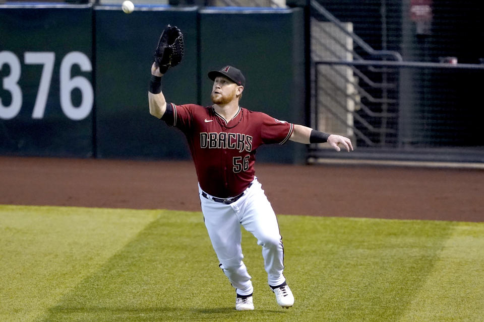 Arizona Diamondbacks' Kole Calhoun catches a fly out hit by Texas Rangers' Nick Solak during the first inning of a baseball game, Wednesday, Sept. 23, 2020, in Phoenix. (AP Photo/Matt York)