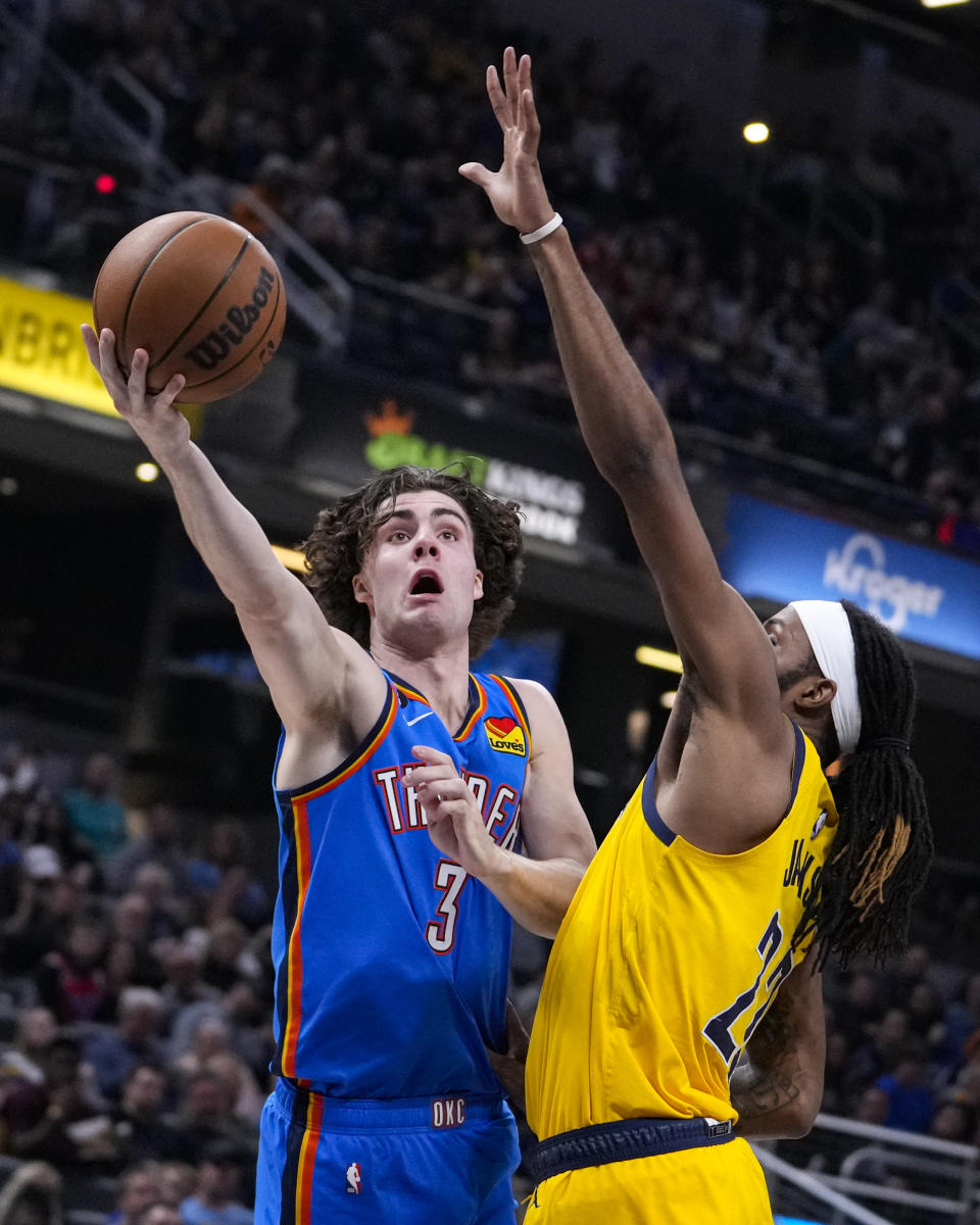 Oklahoma City Thunder guard Josh Giddey (3) shoots around Indiana Pacers forward Isaiah Jackson (22) during the first half of an NBA basketball game in Indianapolis, Friday, March 31, 2023. (AP Photo/Michael Conroy)