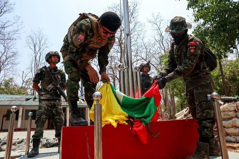 LT Saw Kaw, a soldier of the Karen National Liberation Army (KNLA) in charge of the Cobra column, burns Myanmar's national flag at a Myanmar military base on the outskirts of Myawaddy