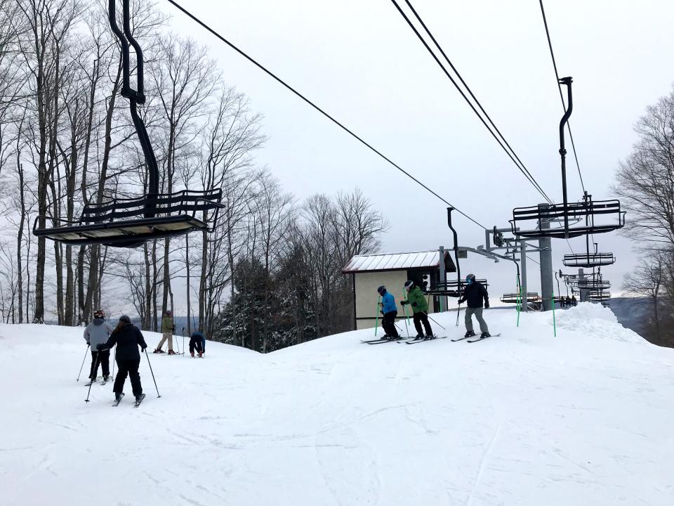 Skiers disembark from the chairlift on Jan. 21, 2023 at The Highlands at Harbor Springs.