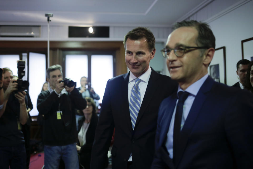 British Foreign Secretary Jeremy Hunt, centre, arrives for a joint news conference with German Foreign Minister Heiko Maas after a meeting at the foreign ministry in Berlin, Wednesday, Feb. 20, 2019. Hunt says London needs a change “of legal significance” to the wording of arrangements meant to ensure the U.K.-Ireland border stays open after Brexit, but isn’t specifying how that might be achieved. (AP Photo/Markus Schreiber)