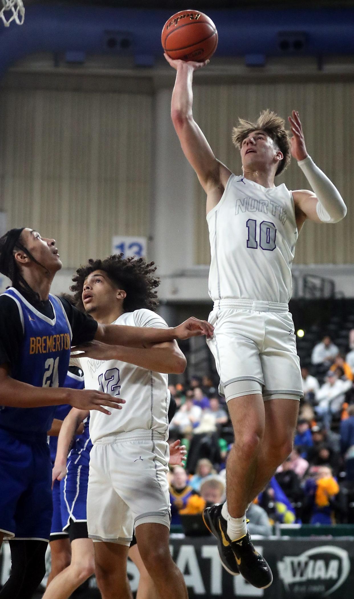 North Kitsap’s Cade Orness (10) takes a shot over Bremerton’s Frank Allen (21) during their Class 2A state championship game at the Yakima SunDome on Saturday, March 2, 2024.