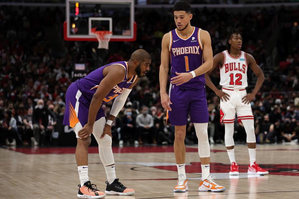 Devin Booker (1) and the Suns will face their first real adversity of the season with Chris Paul (3) possibly missing the remainder of the regular season.