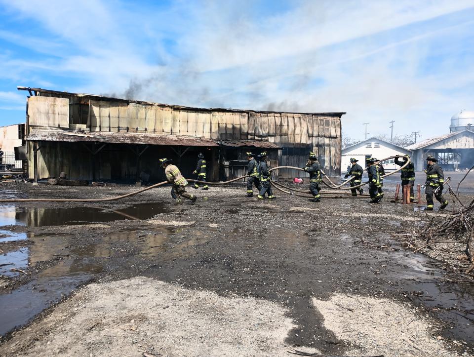 Firefighters and trainees attack a warehouse fire south of Fremont Street in Stockton on April 11, 2023.