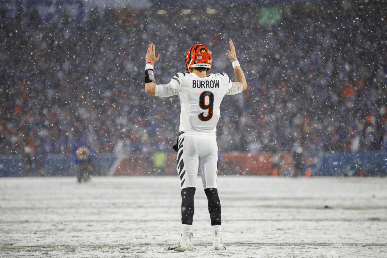 Cincinnati Bengals quarterback Joe Burrow (9) signals for a touchdown during an NFL divisional round playoff football game Sunday, Jan. 22, 2023, in Orchard Park, NY. (AP Photo/Matt Durisko)