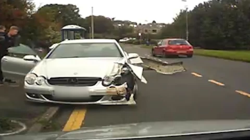 The father quickly checked to see if the driver of the damaged car was okay before pointing out the young child that was on board his car. Photo: LiveLeak