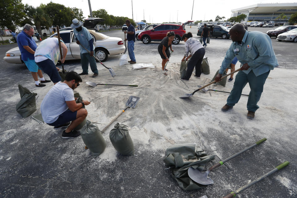 Residents fill up sandbags with the last bits of sand available in preparation for Hurricane Dorian, Friday, Aug. 30, 2019, in Hallandale Beach, Fla., as the town allowed residents to fill up sandbags until they ran out. All of Florida is under a state of emergency and authorities are urging residents to stockpile a week&#39;s worth of food and supplies as Hurricane Dorian gathers strength and aims to slam the state as soon as Monday as a Category 4 storm. (AP Photo/Wilfredo Lee)