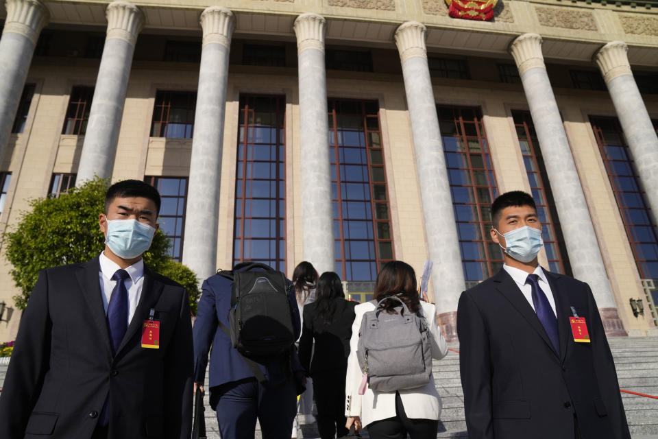 Security personnel stand guard in front of the Great Hall of the People before the opening ceremony for the 20th National Congress of China's ruling Communist Party in Beijing, China, Sunday, Oct. 16, 2022. China on Sunday opens a twice-a-decade party conference at which leader Xi Jinping is expected to receive a third five-year term that breaks with recent precedent and establishes himself as arguably the most powerful Chinese politician since Mao Zedong. (AP Photo/Mark Schiefelbein)