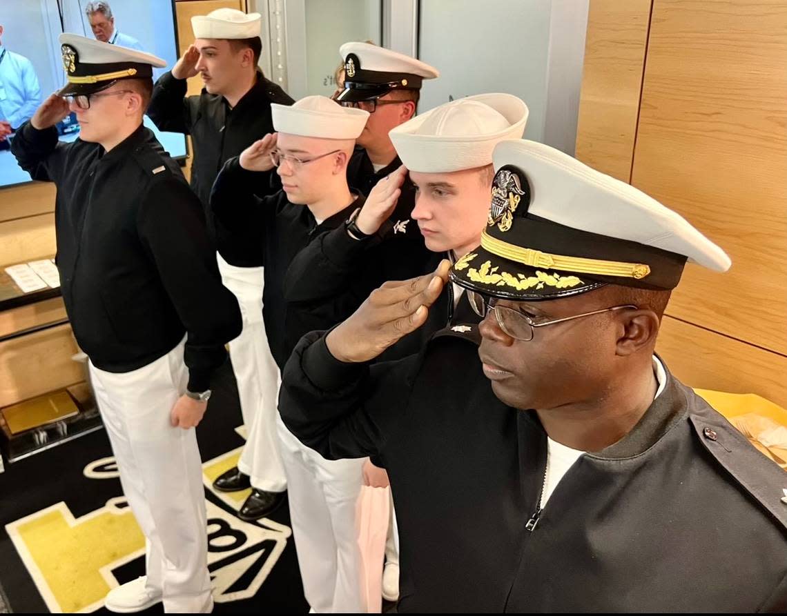 USS Idaho Cmdr. Randall Leslie, in foreground, and USS Idaho crew members salute during the playing of the national anthem at a recent University of Idaho football game as part of a visit to Idaho, sponsored by the USS Idaho Commissioning Committee.