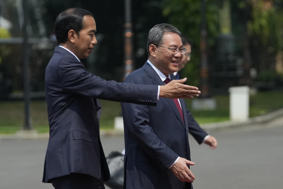 Indonesian President Joko Widodo, left, shows the way to Chinese Premier Li Qiang upon Li's arrival for their meeting at Merdeka Palace in Jakarta, Indonesia, Friday, Sept. 8, 2023. (AP Photo/Achmad Ibrahim)