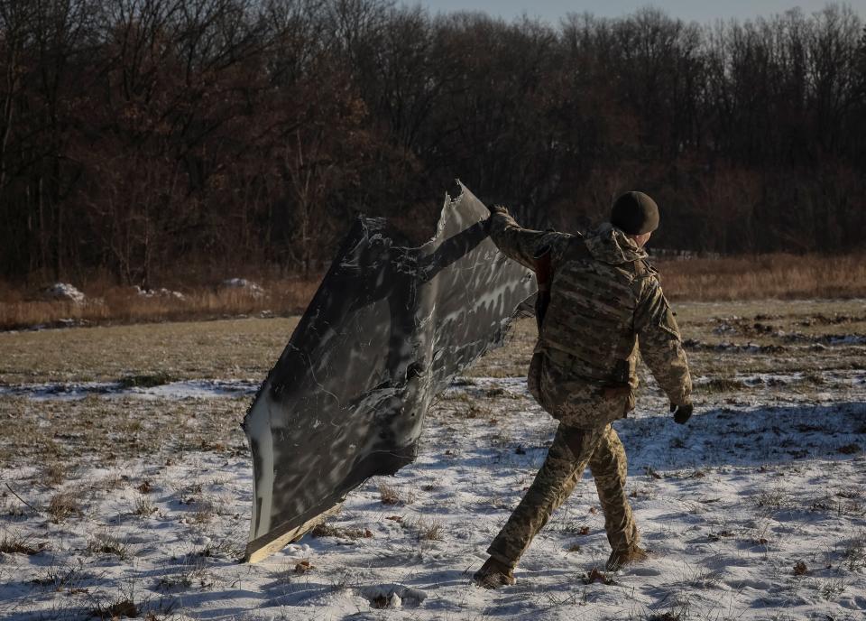 A Ukrainian serviceman from air defence unit carries a part of a Russian suicide drone downed a few days ago at his position (REUTERS)