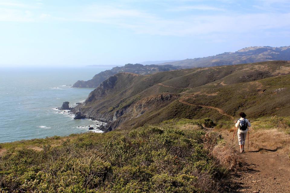 A woman hiking on the Coastal Trial