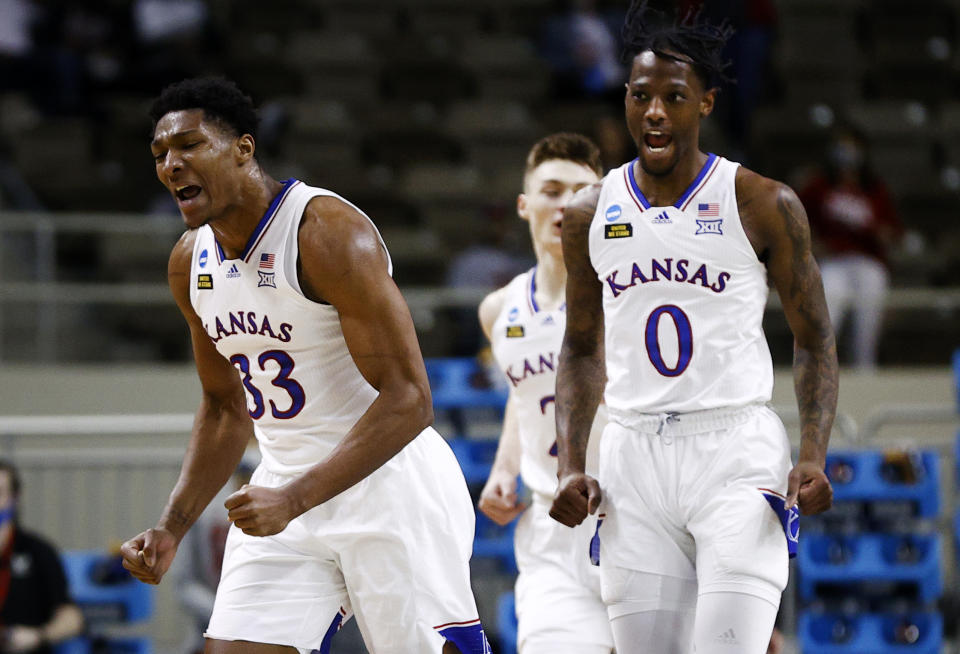 David McCormack #33 of the Kansas Jayhawks and Marcus Garrett #0 of the Kansas Jayhawks react to a basket during the first half against the Eastern Washington Eagles in the first round game of the 2021 NCAA Men's Basketball Tournament at Indiana Farmers Coliseum on March 20, 2021 in Indianapolis, Indiana. (Photo by Maddie Meyer/Getty Images)