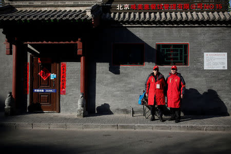 Public security volunteers pose for pictures during their duty ahead of the upcoming plenary session of National People's Congress (NPC), China's parliamentary body, in Beijing, China, March 1, 2018. REUTERS/Thomas Peter