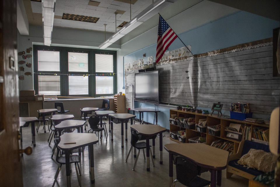 FILE - An empty elementary school classroom is seen on Tuesday, Aug. 17, 2021 in the Bronx borough of New York. Nationwide, students have been absent at record rates since schools reopened after COVID-forced closures. More than a quarter of students missed at least 10% of the 2021-22 school year. (AP Photo/Brittainy Newman, File)