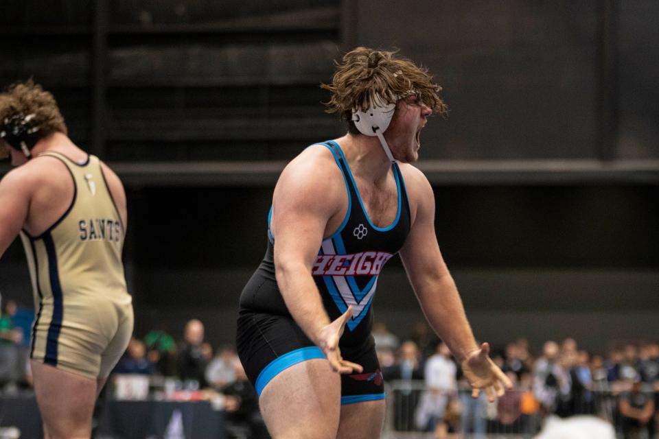 Shawnee Heights' Rykan Carver celebrates winning the 5A 215 weight class state title on Saturday, Feb. 24, 2024.