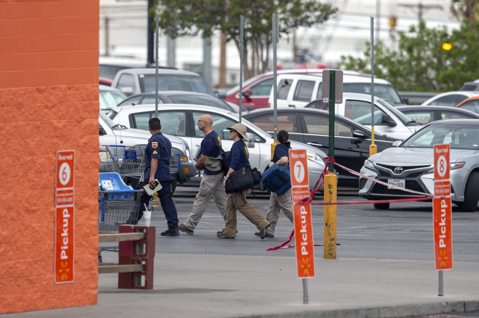 FBI agents arrive to the Walmart store in the aftermath of a mass shooting in El Paso, Texas, Sunday, Aug. 4, 2019. A gunman opened fire Saturday killing over a dozen. (AP Photo/Andres Leighton)