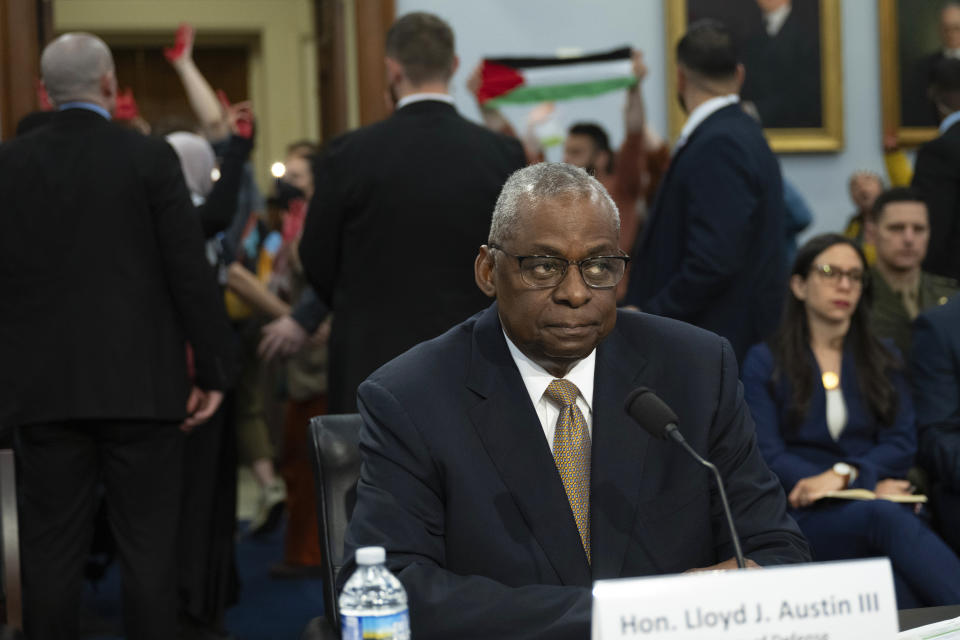 Sec of Defense Lloyd Austin pauses his testimony as demonstrators protesting Israel's military action in Gaza with U.S. weapons during a House Committee on Appropriations, Subcommittee on Defense budget hearing Fiscal Year 2025 on Capitol Hill, Wednesday, April 17, 2024 in Washington. (AP Photo/John McDonnell)