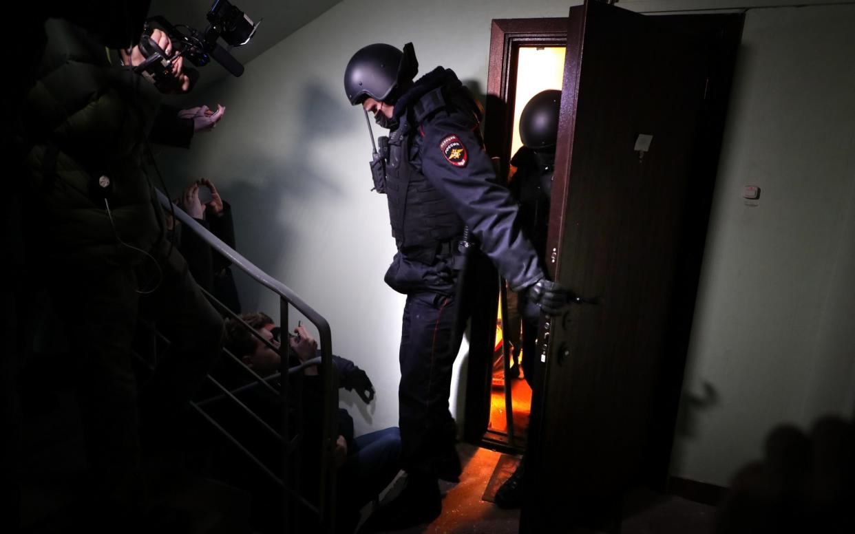 Policemen leave the flat of opposition leader Alexei Navalny in Moscow on January 27 - SERGEI ILNITSKY/EPA-EFE/Shutterstock 