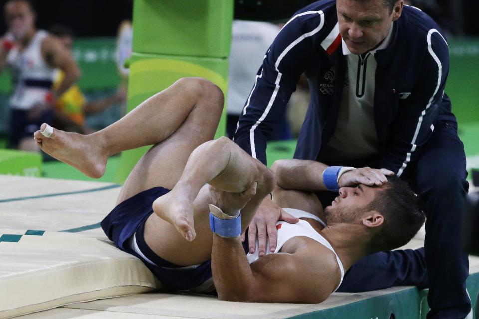 France&#39;s Samir Ait Said holds his leg after injuring it while performing on the vault during the artistic gymnastics men&#39;s qualification at the 2016 Summer Olympics in Rio de Janeiro, Brazil, Saturday, Aug. 6, 2016. (AP Photo/Rebecca Blackwell)