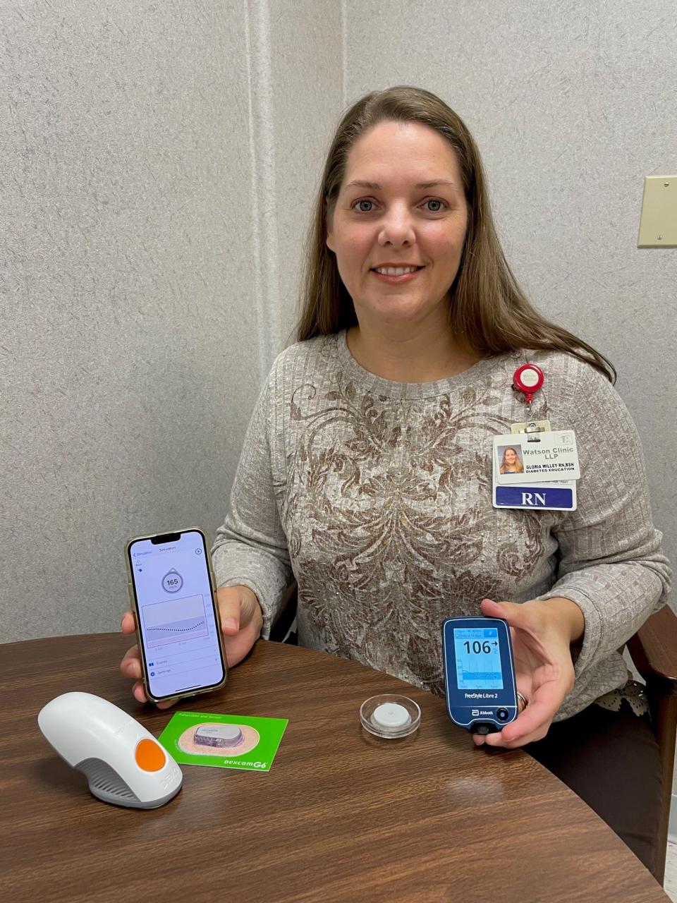 Continuous glucose monitoring system elements being displayed by Gloria Willey, a registered nurse who is certified diabetes care and education specialist at Watson Clinic in Lakeland.