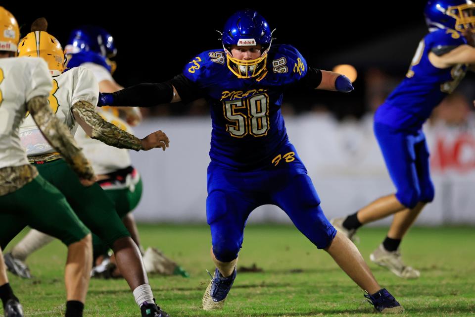 Fernandina Beach offensive lineman Nolan Blackard (58) makes a block during a September 2023 game against Yulee. The senior, born with one hand, signed to play college football at Southeastern University in Lakeland.