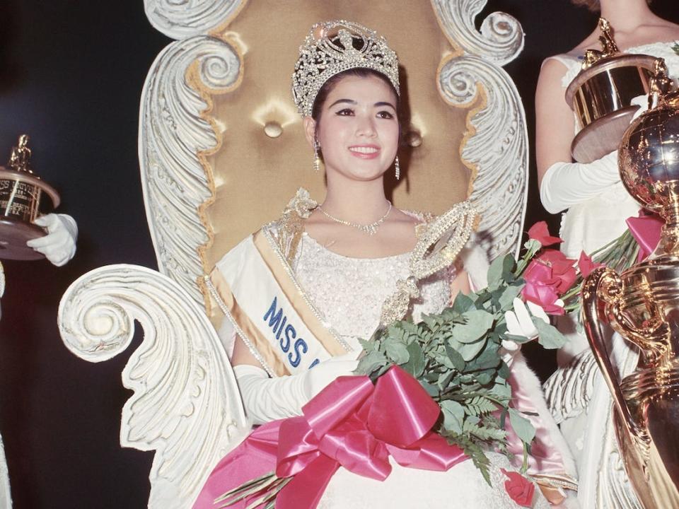 Miami Beach, Florida....Close-up of "Miss Universe," 1965, Apasra Hongsakula of Thailand shortly after she won the title, July 24. At right is Ingrid Norman, Miss Sweden, third runner-up. At front is "Miss Universe" trophy.