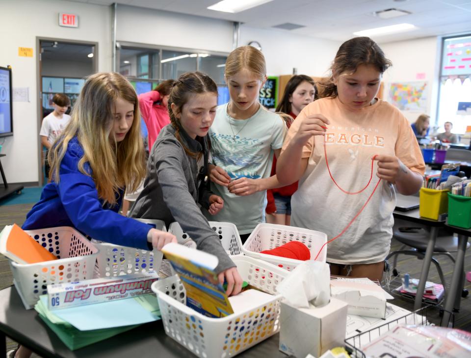 Fifth grade students Kendal Pigott, Holly Gant, Avery Henry and Ava Nixon work to build a boat in class at Lake Elementary School.  Friday,  April 14, 2023.