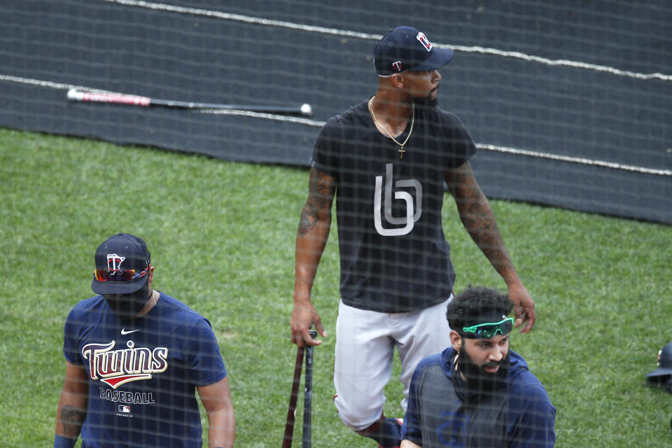 Minnesota Twins' Byron Buxton, center, Marwin Gonzalez, right, and another player head to the batting cage during baseball training Wednesday, July 8, 2020, in Minneapolis. Count Buxton among the players who probably benefited from baseball's virus-induced delay. The oft-injured Twins center fielder was coming off major shoulder surgery. After a late arrival due to the birth of his second child, Buxton is in camp at full speed. (AP Photo/Jim Mone)