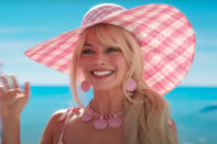 <p>Barbie is always perfectly accessorized, even at the beach! Robbie is seen in another pink gingham dress (with a heart cutout at the back) and perfectly-matched sun hat, plus pink seashell jewelry. </p>