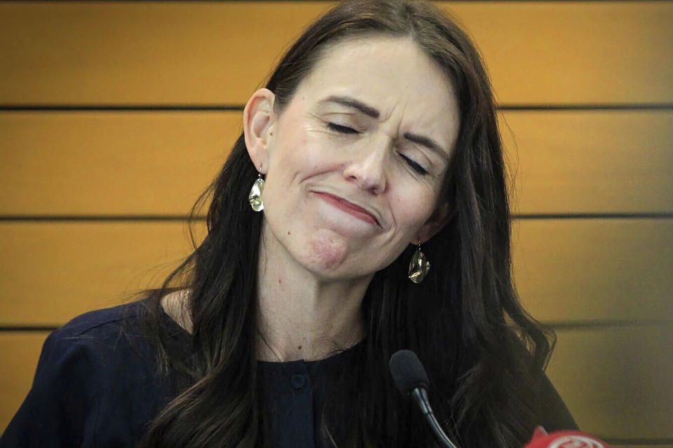 New Zealand Prime Minister Jacinda Ardern grimaces as she announces her resignation at a press conference in Napier, New Zealand. Fighting back tears, Ardern told reporters that Feb. 7 will be her last day in office. (Warren Buckland/New Zealand Herald via AP)