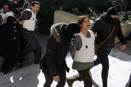 Eight men and a woman holding Turkish citizenship, who were arrested on suspected links to a leftist militant group outlawed in Turkey following an operation by Greek security services, are escorted by anti-terrorism police officers to the prosecutor's office in Athens, Greece, November 29, 2017. REUTERS/Alkis Konstantinidis