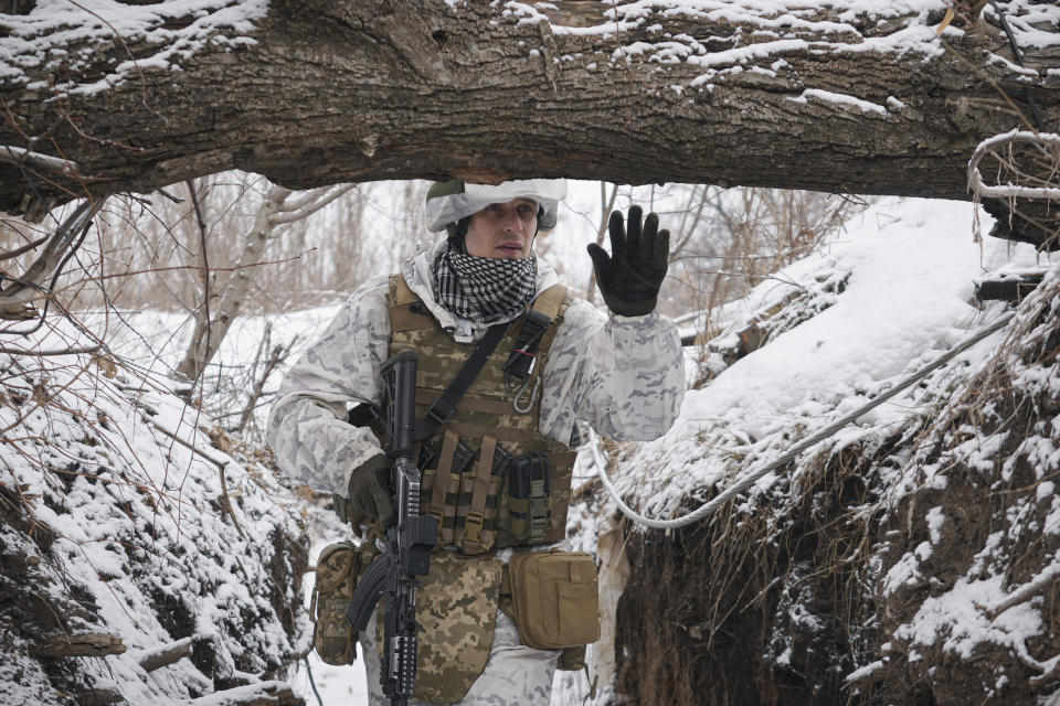 A Ukrainian serviceman patrols along a frontline position outside Avdiivka, Donetsk region, eastern Ukraine, Saturday, Feb. 5, 2022. The French president and the German chancellor will head to Moscow and Kyiv in the coming weeks, adding to diplomatic efforts to try to deter Russian President Vladimir Putin from launching an invasion of Ukraine and find a way out of the growing tensions. (AP Photo/Vadim Ghirda)