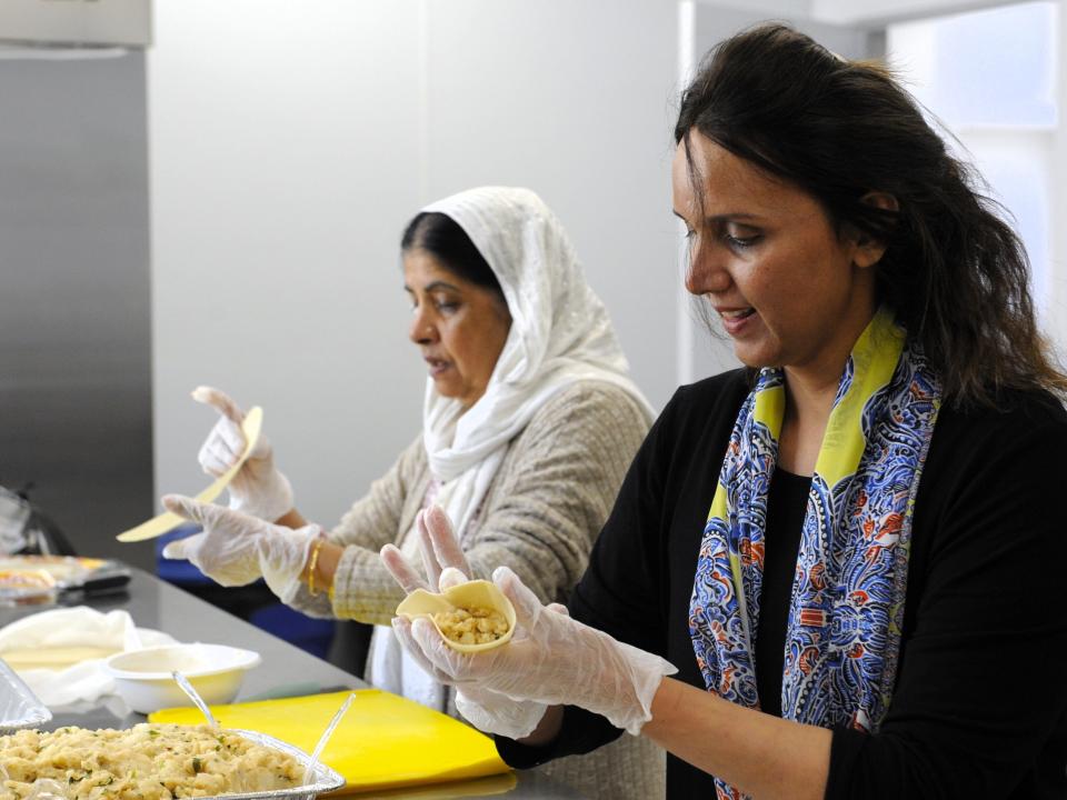 Robina Asghar, left, and Samaira Ahmed work together to prepare samosas, fried pastries filled with spiced potatoes, for the Islamic Society of Evansville's International Food Festival, on Monday, Sept.18, 2023.