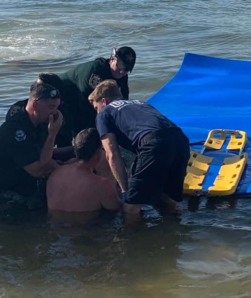 First responders help pull a woman to shore on a large float Sunday after she was injured from jumping off a pontoon boat in Choctawhatchee Bay.