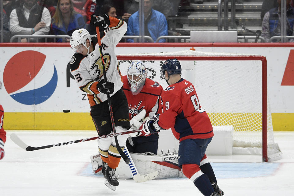 Anaheim Ducks right wing Jakob Silfverberg (33), of Sweden, looks for the puck next to Washington Capitals defenseman Dmitry Orlov (9), of Russia, and goaltender Braden Holtby, center, during the third period of an NHL hockey game, Monday, Nov. 18, 2019, in Washington. The Capitals won 5-2. (AP Photo/Nick Wass)