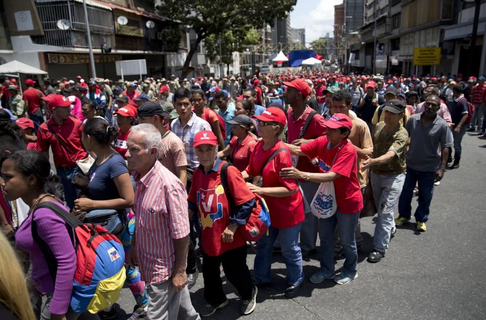 Members of the Bolivarian Militia gather outside Miraflores presidential palace in Caracas, Venezuela, Tuesday, March 12, 2019. Members of the militia, which were formed the late President Hugo Chavez, met to show support for embattled President Nicolas Maduro after nearly a week of national blackouts while their country reels from economic and political calamity. (AP Photo/Ariana Cubillos)