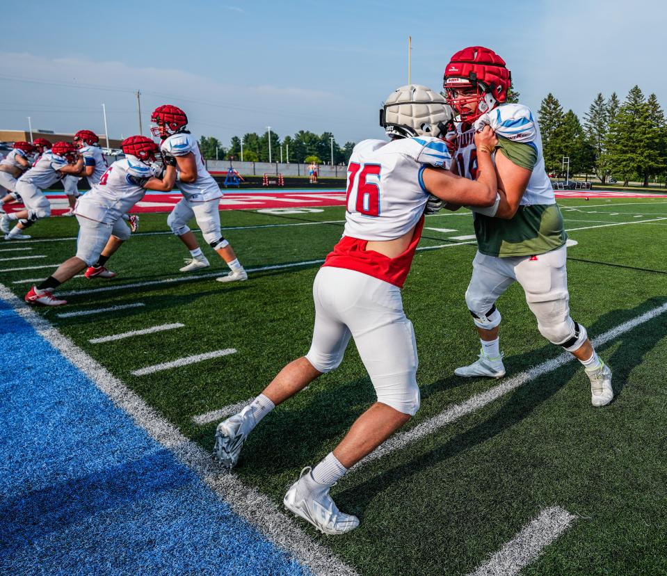 Arrowhead offensive lineman Derek Jensen, right, will play for the Wisconsin Badgers in college.