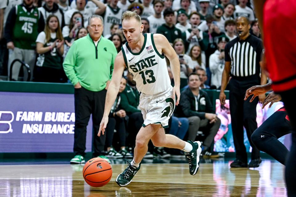 Michigan State's Steven Izzo crosses over his man while moving to the basket during the second half in the game against Rutgers on Sunday, Jan. 14, 2024, at the Breslin Center in East Lansing.